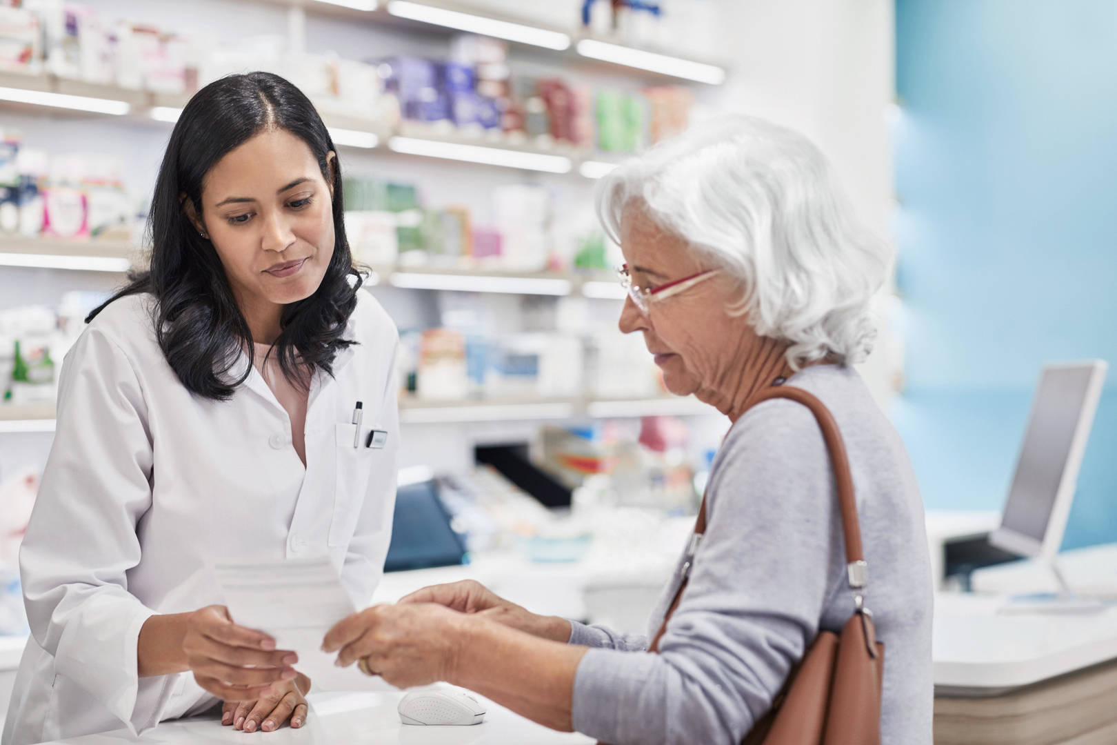 female pharmacist with elderly female patient