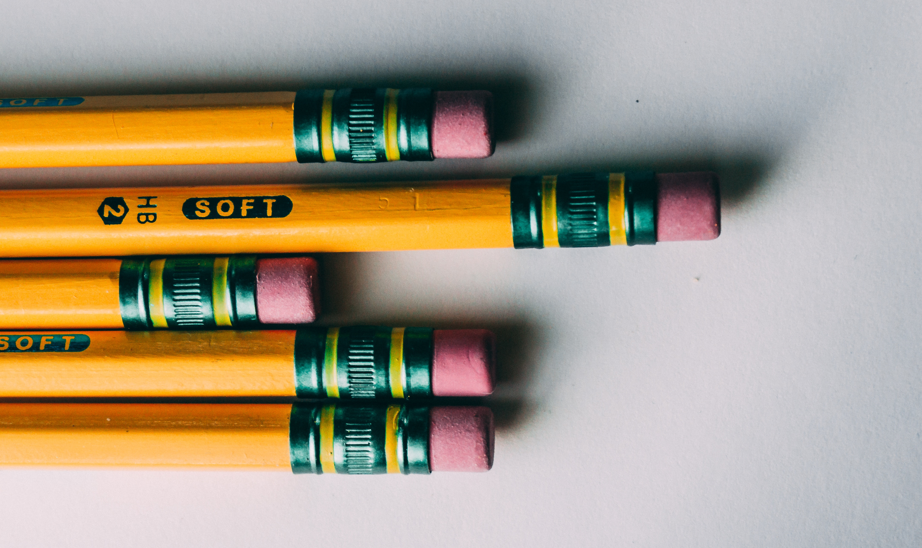 Five pencils lined up side by side